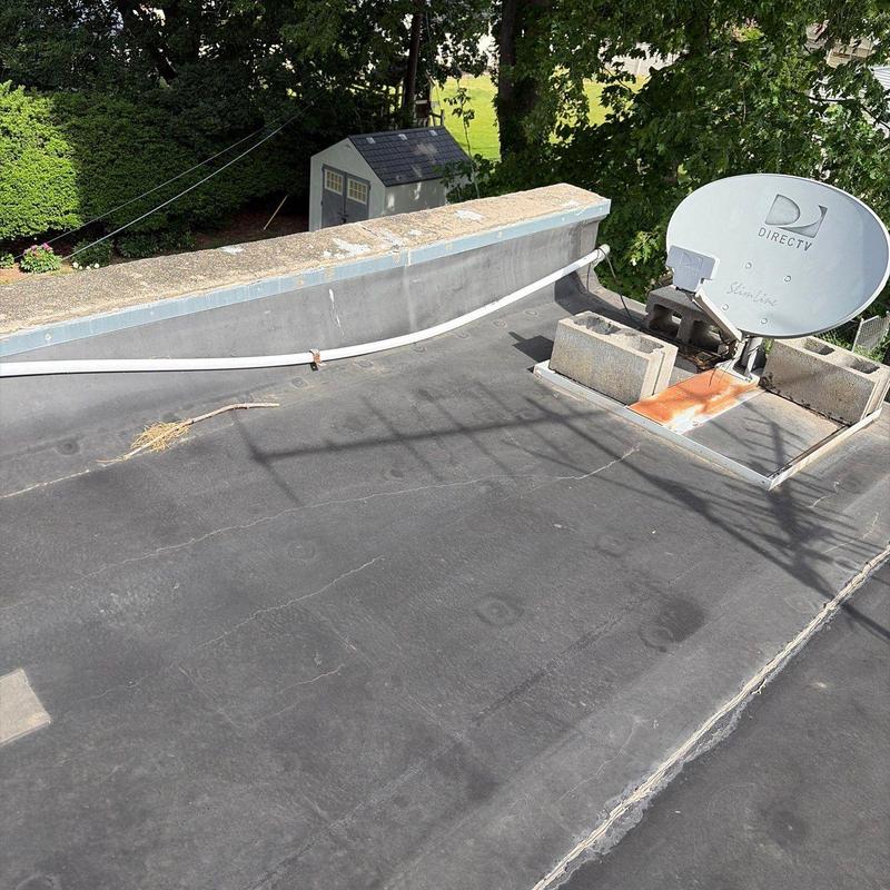 Flat roofing with satellite dish and weathering marks Flat roofing with satellite dish and weathering marks