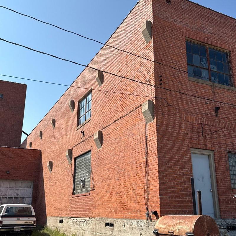 Brick exterior wall of commercial building with windows Brick exterior wall of commercial building with windows