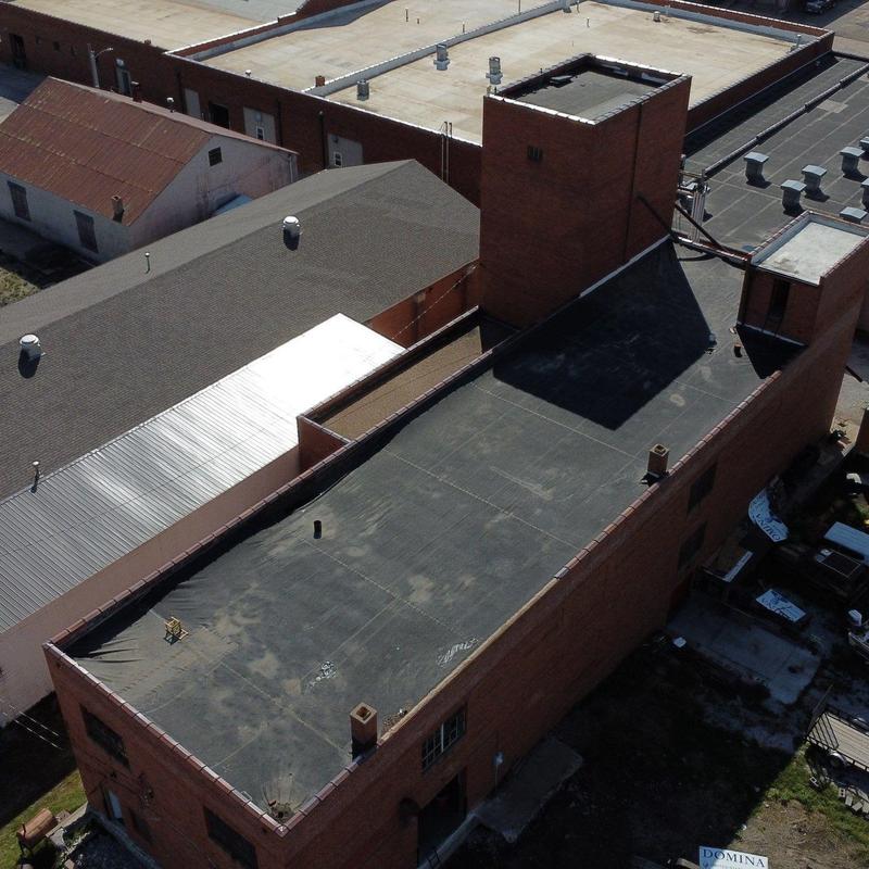 Flat commercial roof with ventilation stacks and brick walls Flat commercial roof with ventilation stacks and brick walls