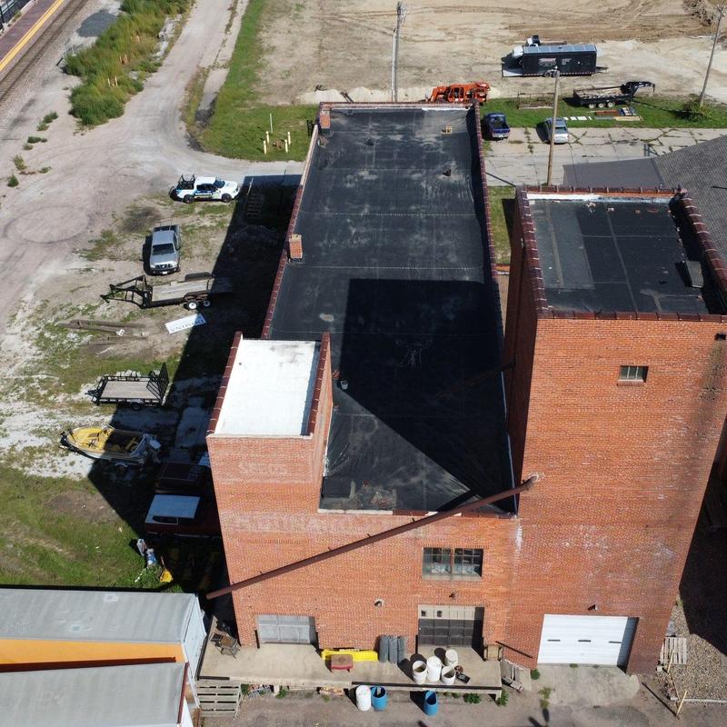 Flat roof membrane inspection on brick building Flat roof membrane inspection on brick building