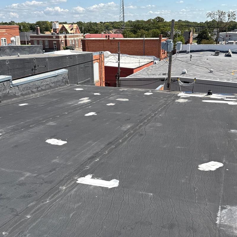 Flat roof membrane with patch repairs and seams Flat roof membrane with patch repairs and seams