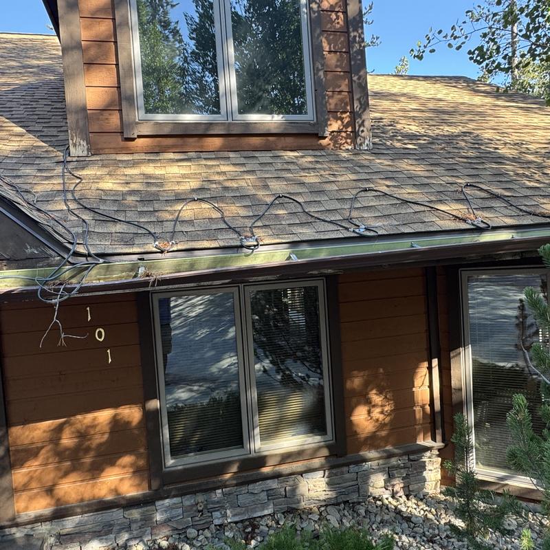Asphalt shingle roof with damaged heat tape installation