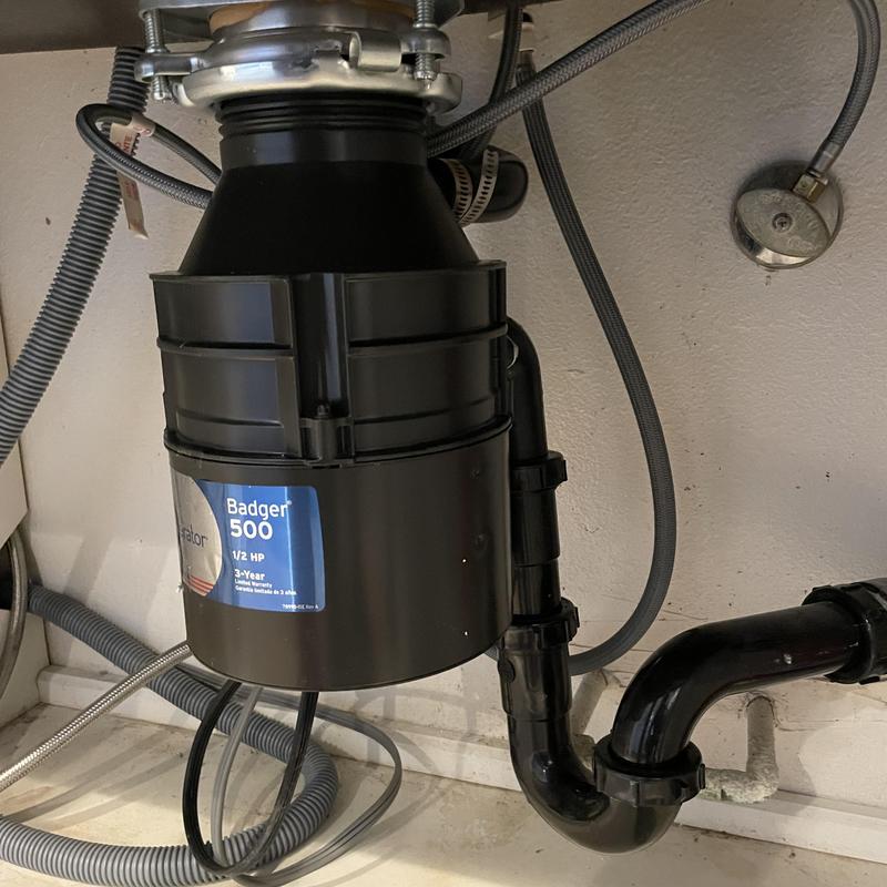 Garbage disposal unit with plumbing connections installed Garbage disposal unit with plumbing connections installed