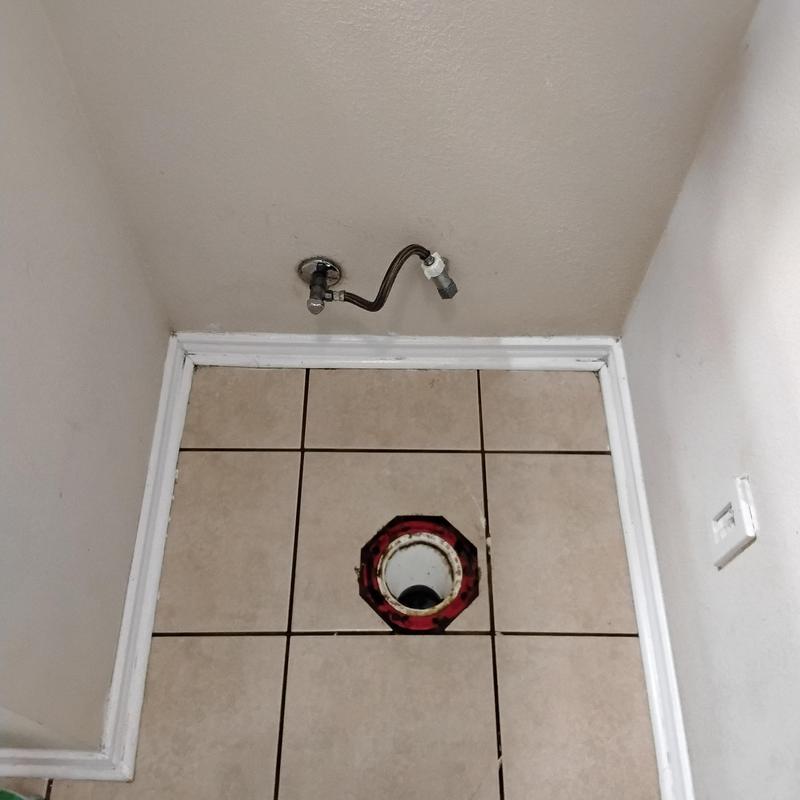Toilet flange installation on tiled floor with water supply line