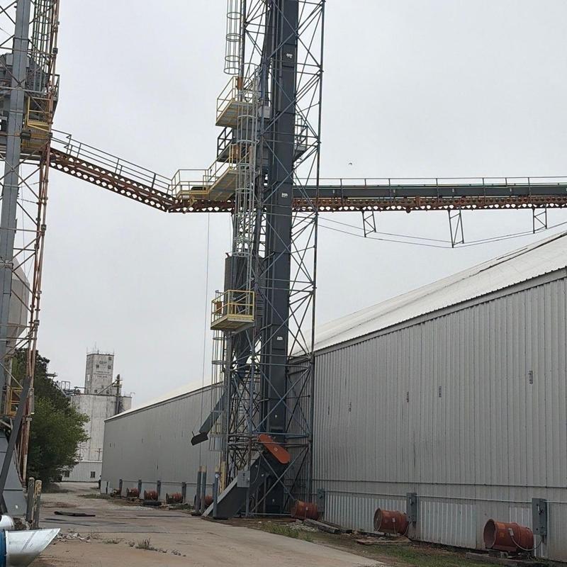 Industrial grain elevator system with metal building background Industrial grain elevator system with metal building background