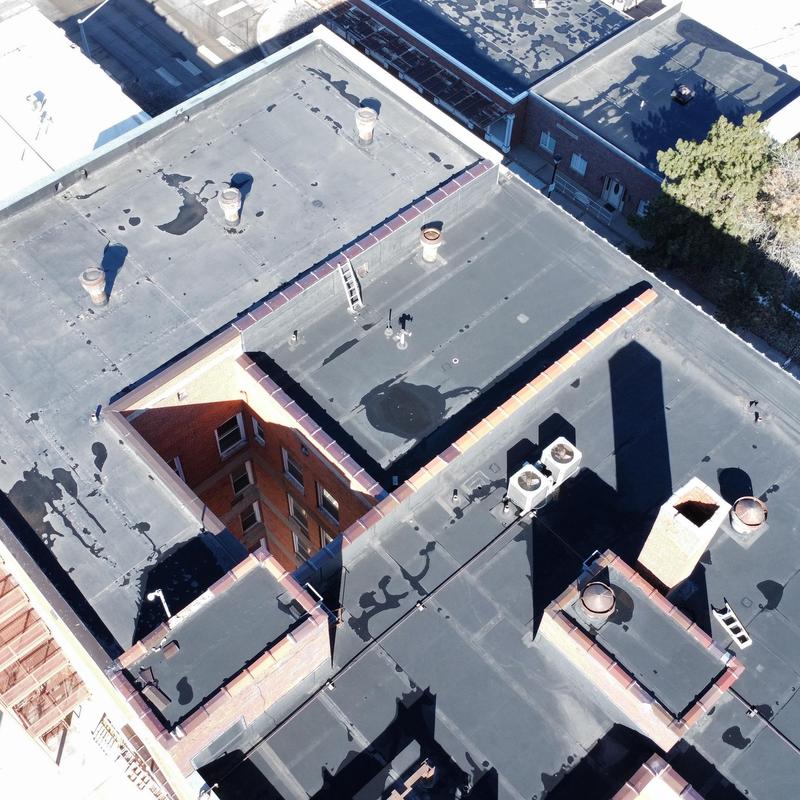 Flat commercial roofing with vents and HVAC units Flat commercial roofing with vents and HVAC units