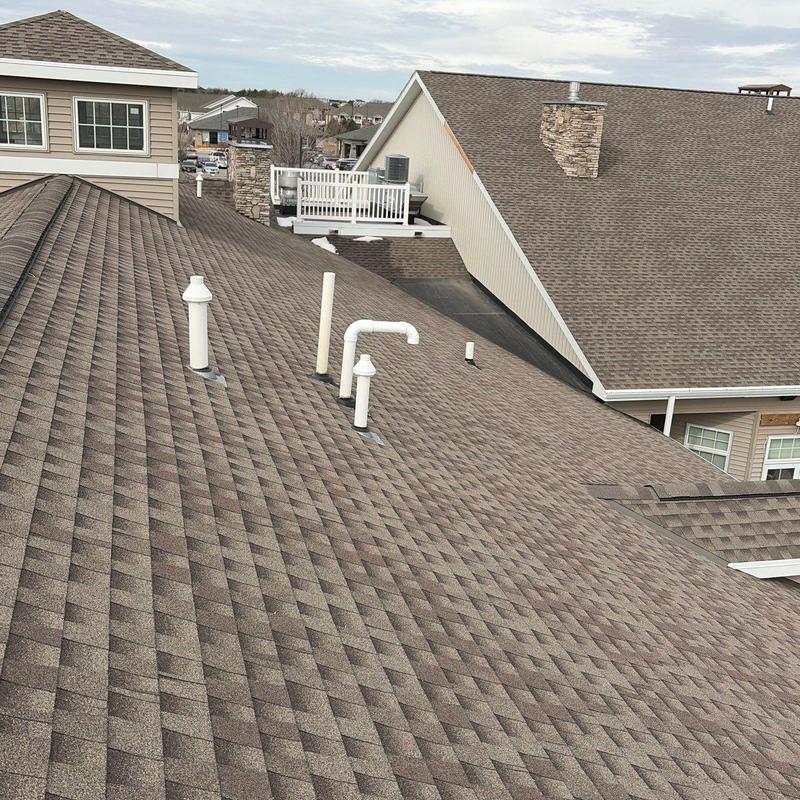 Asphalt shingle roof with plumbing vents in residential area Asphalt shingle roof with plumbing vents in residential area