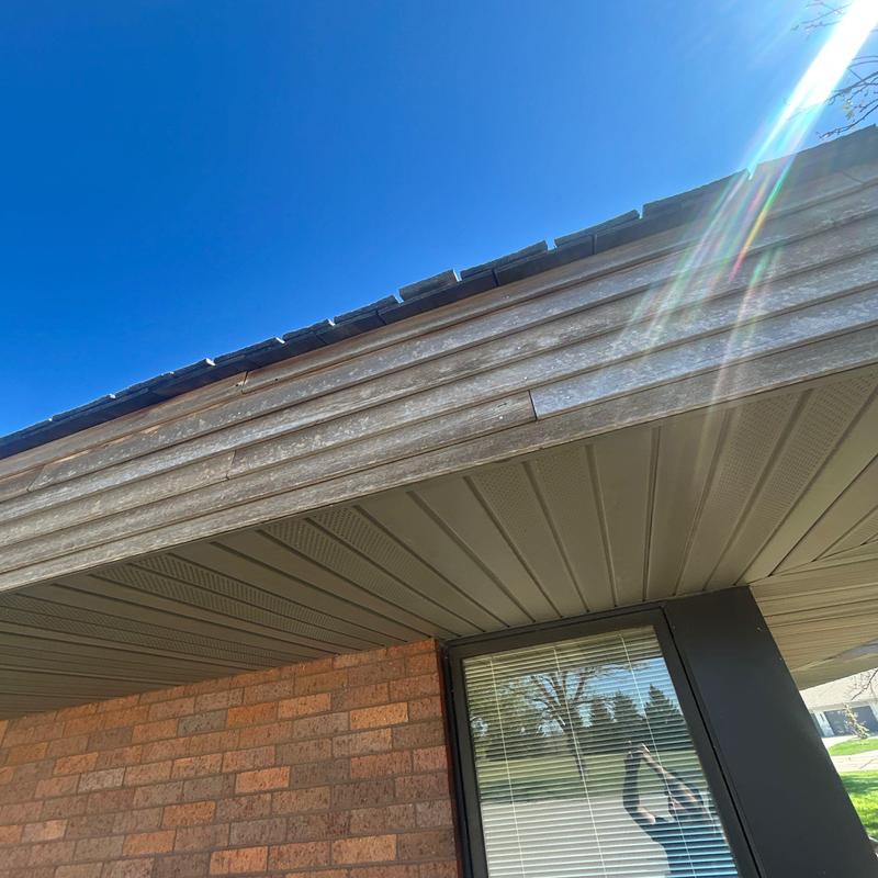 Roof fascia and soffit with sun flare above window Roof fascia and soffit with sun flare above window