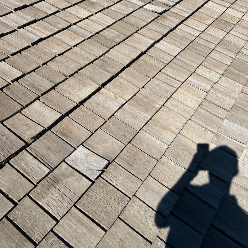 Wood shingle roof with slight tile warping and shadow Wood shingle roof with slight tile warping and shadow