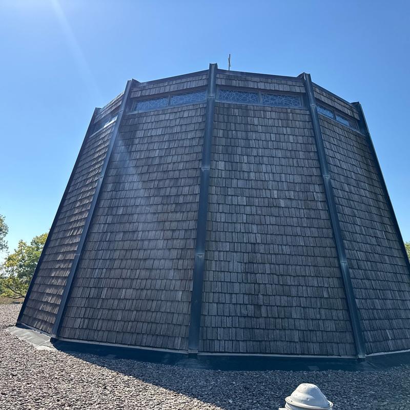 Wood shingle roof with metal flashing and stained glass windows Wood shingle roof with metal flashing and stained glass windows