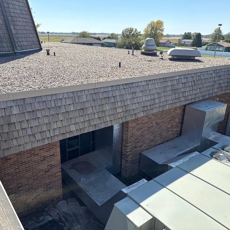 Gravel flat roof with HVAC ductwork and vents Gravel flat roof with HVAC ductwork and vents