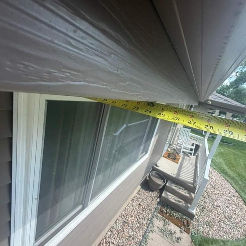 Window frame measurement with tape on house exterior Window frame measurement with tape on house exterior