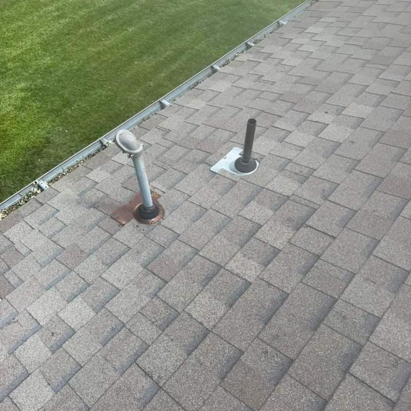 Roof vent pipes and shingles inspection on residential roof Roof vent pipes and shingles inspection on residential roof