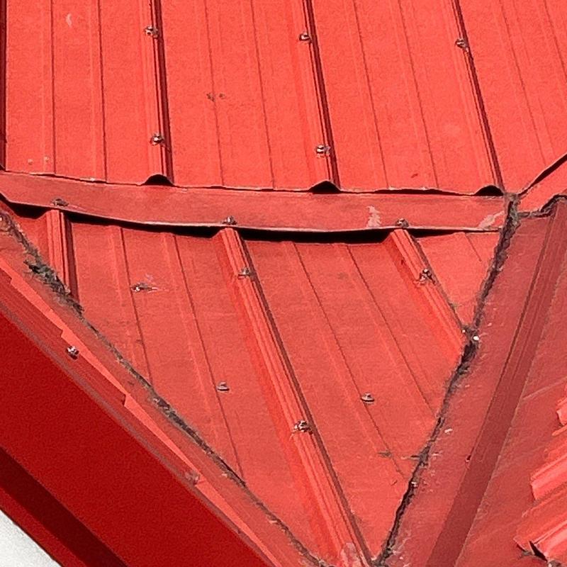 Metal roof panels with hail damage and bent edges