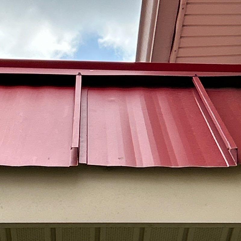 Metal roof panels showing hail damage and dents