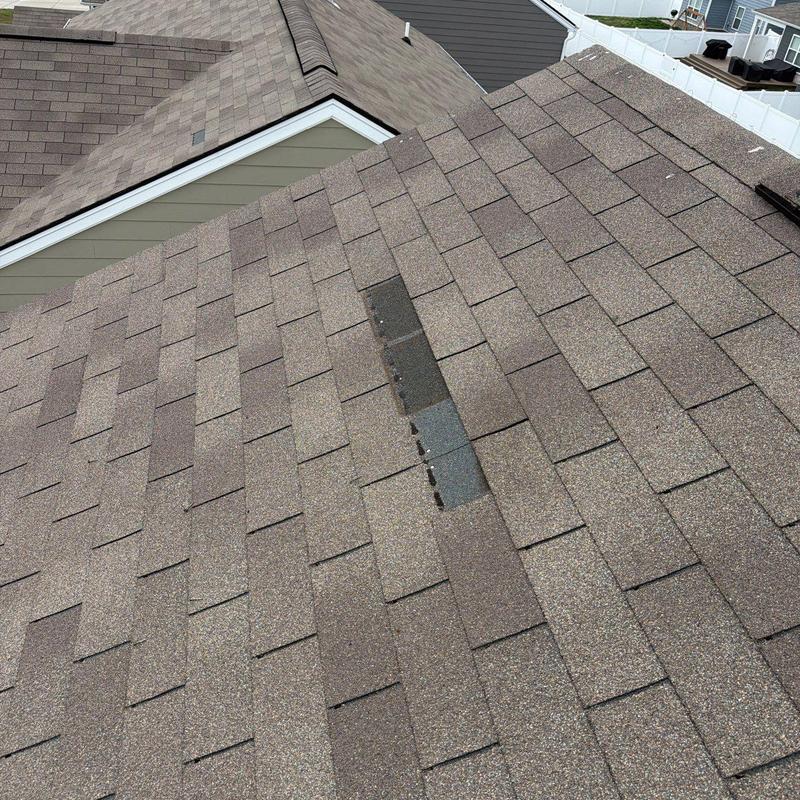 Roof shingles with hail damage and missing granules
