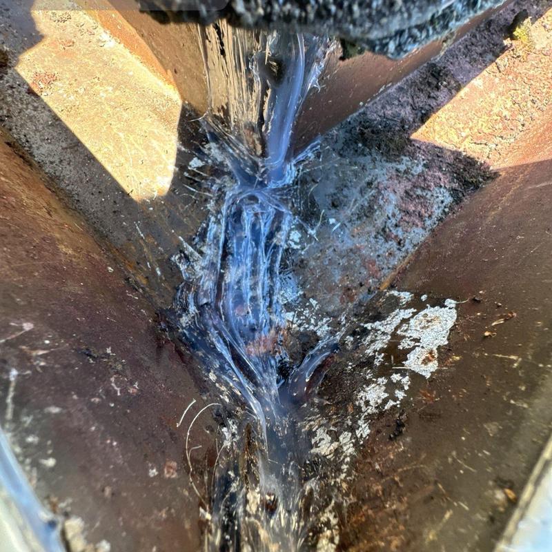 Gutter joint sealed with waterproof roofing sealant