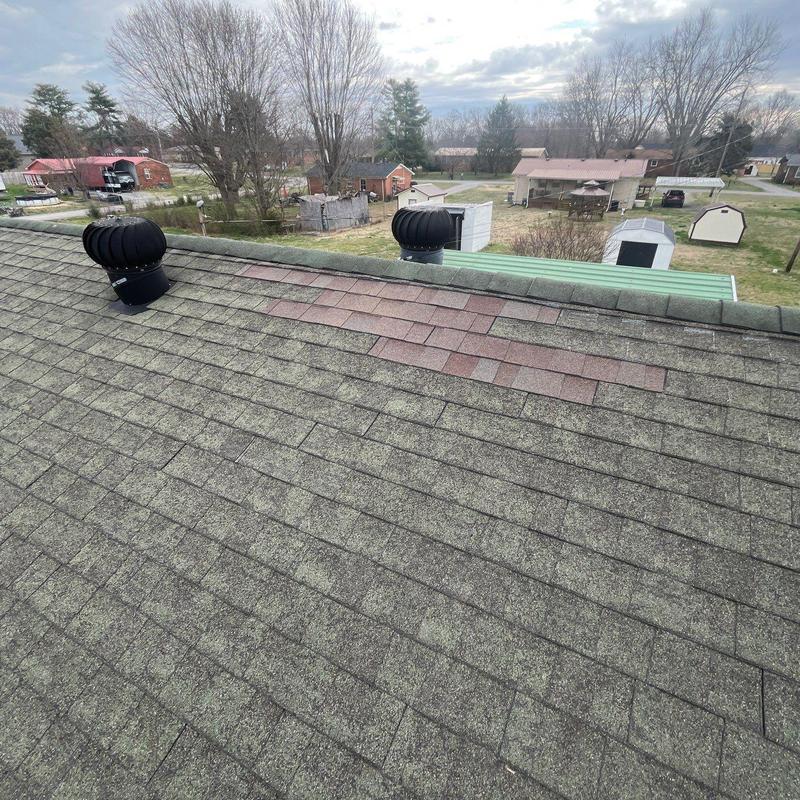 Roof shingles with patch repair on residential roof