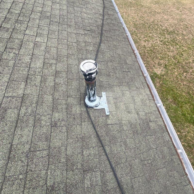 Roof vent pipe flashing with hail damage on shingles
