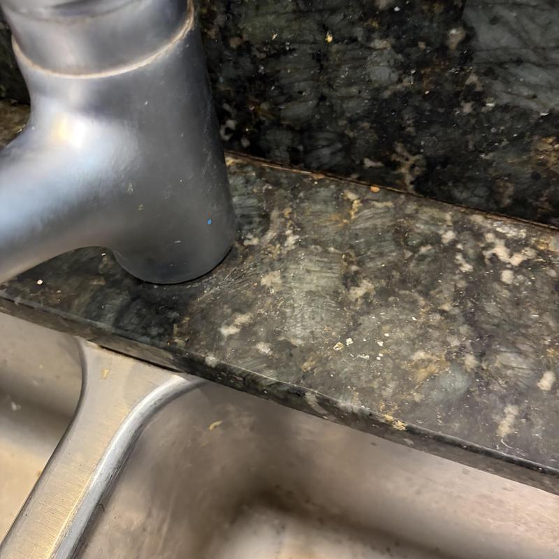 Kitchen sink faucet and countertop installation close-up Kitchen sink faucet and countertop installation close-up