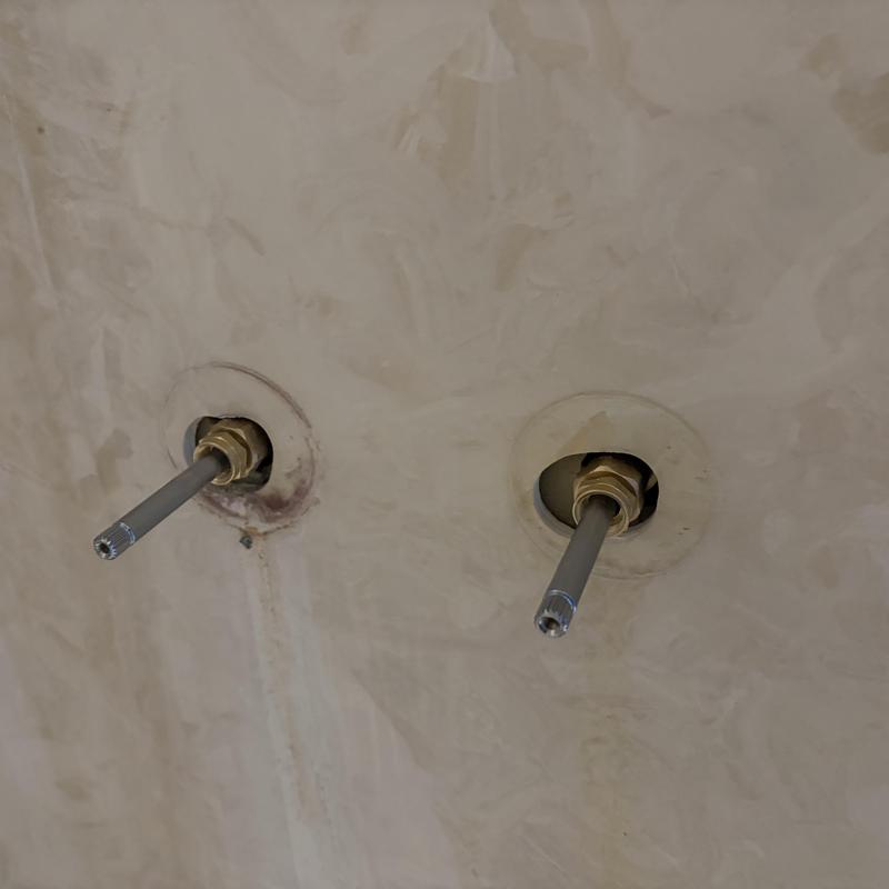Two-handle shower faucet stems installed in wall Two-handle shower faucet stems installed in wall