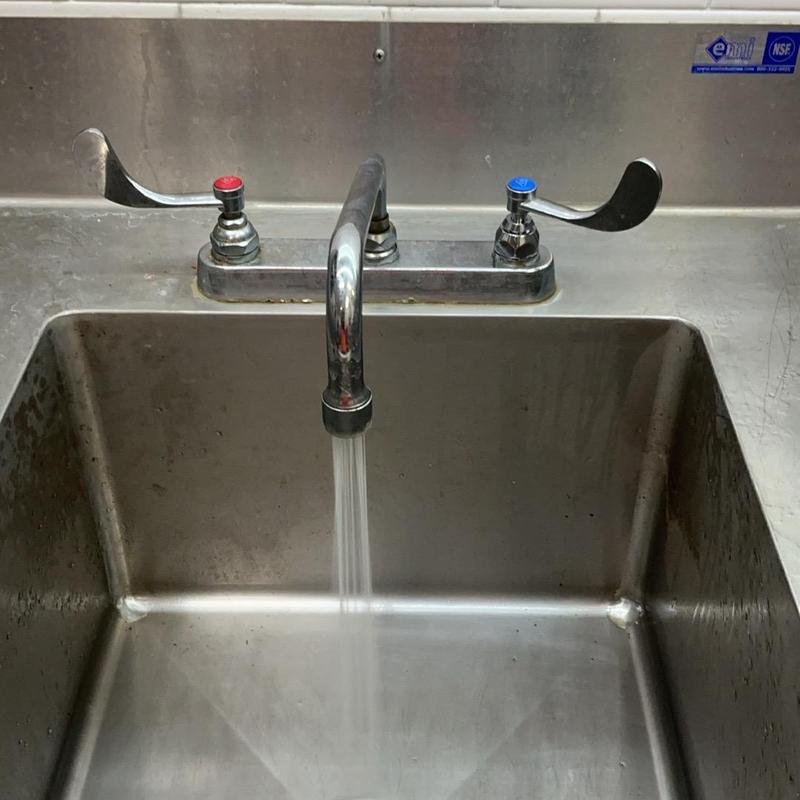 Cold cartridge faucet with running water in stainless sink Cold cartridge faucet with running water in stainless sink