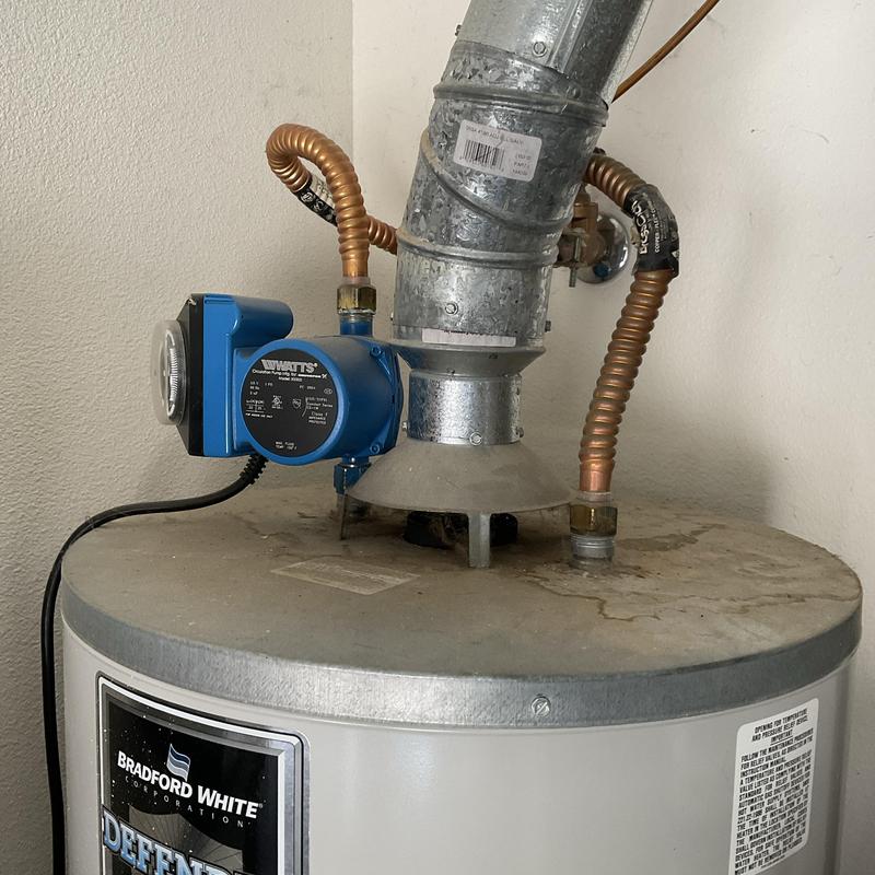 Water heater ventilation pipe and circulation pump close-up Water heater ventilation pipe and circulation pump close-up