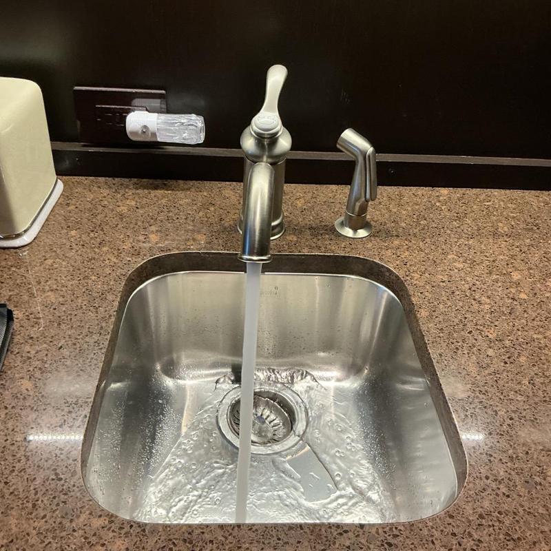 Kohler faucet with running water in stainless sink Kohler faucet with running water in stainless sink