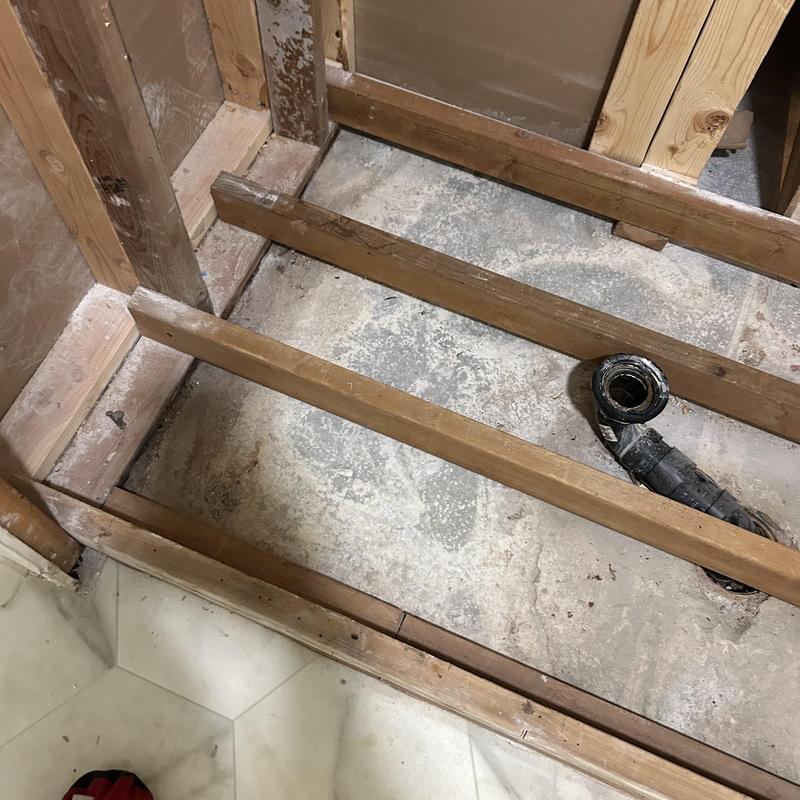 Shower drain pipe and floor framing exposed for repair Shower drain pipe and floor framing exposed for repair