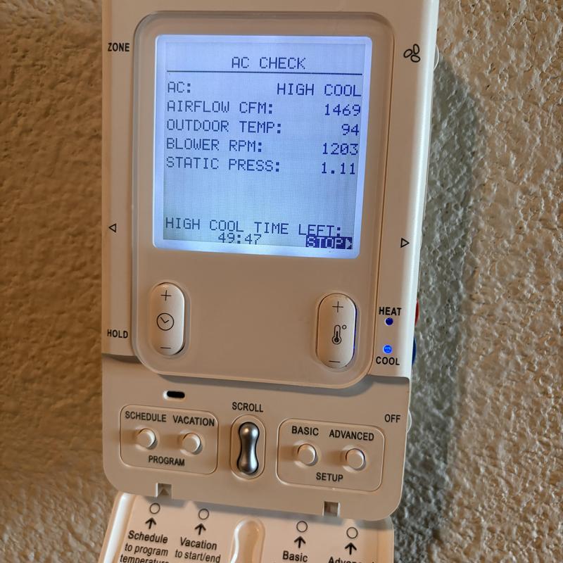 Thermostat display showing AC performance readings