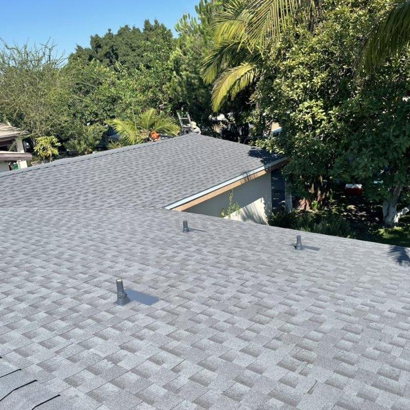 Gray shingle roofing with vents on residential house Gray shingle roofing with vents on residential house