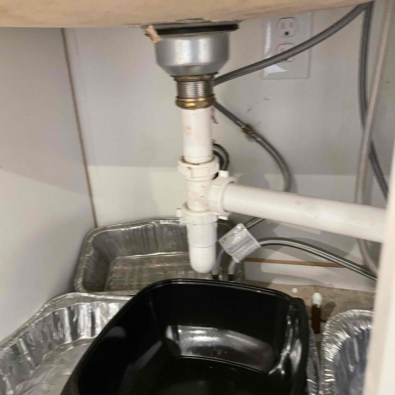 Tubular pipe below sink with leak catch trays Tubular pipe below sink with leak catch trays