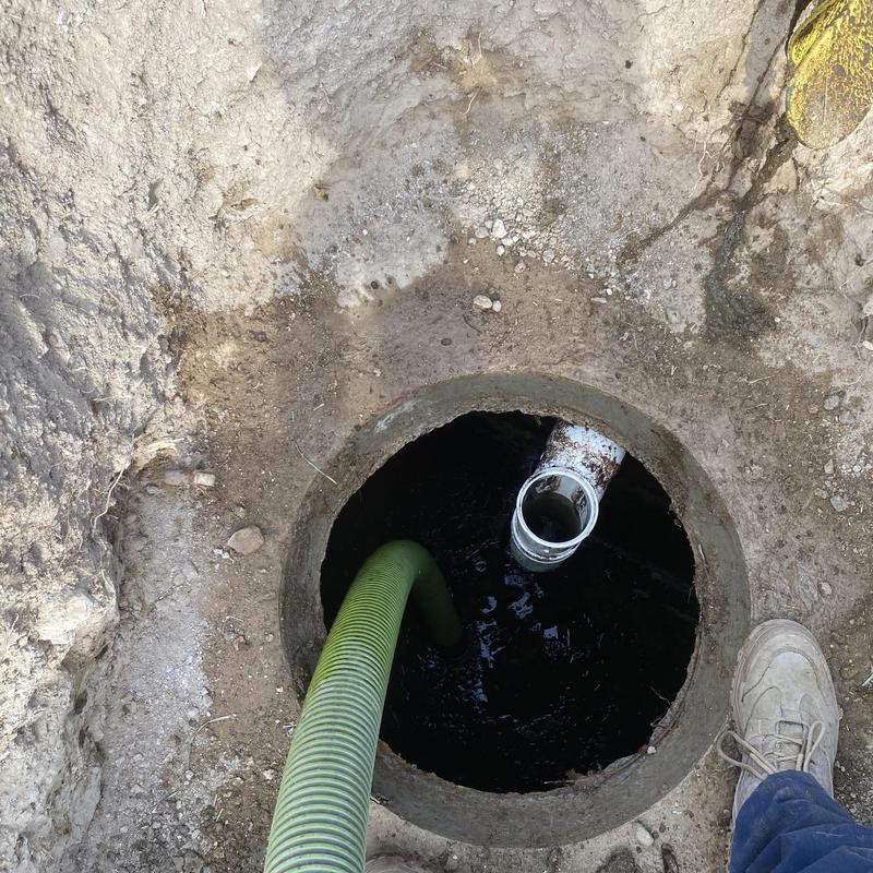Septic tank inspection and solids removal in dirt pit Septic tank inspection and solids removal in dirt pit