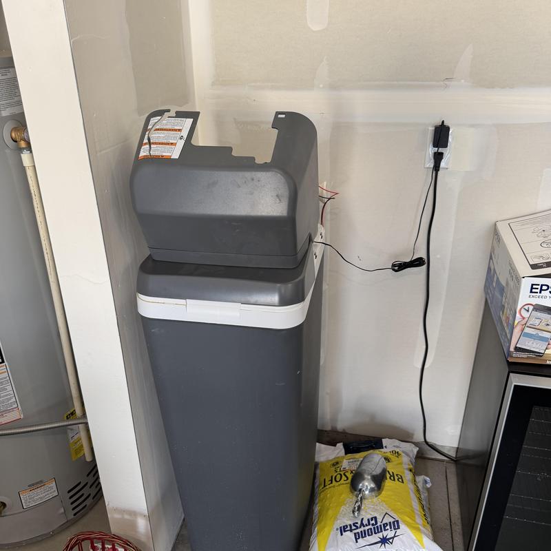 Water softener system with motor wiring exposed Water softener system with motor wiring exposed