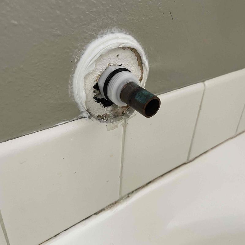 Copper tub spout stub out with damaged wall surrounding it Copper tub spout stub out with damaged wall surrounding it