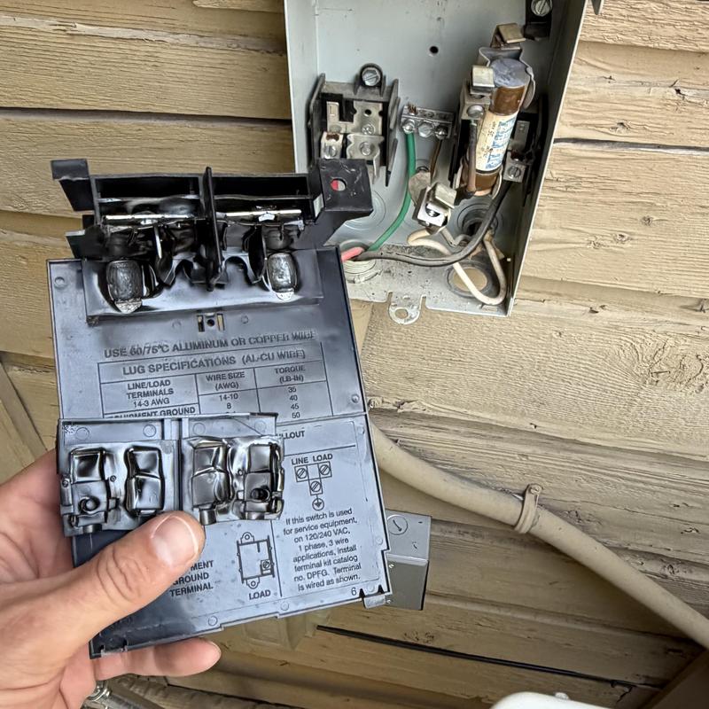 Electrical disconnect box with melted contacts removed Electrical disconnect box with melted contacts removed