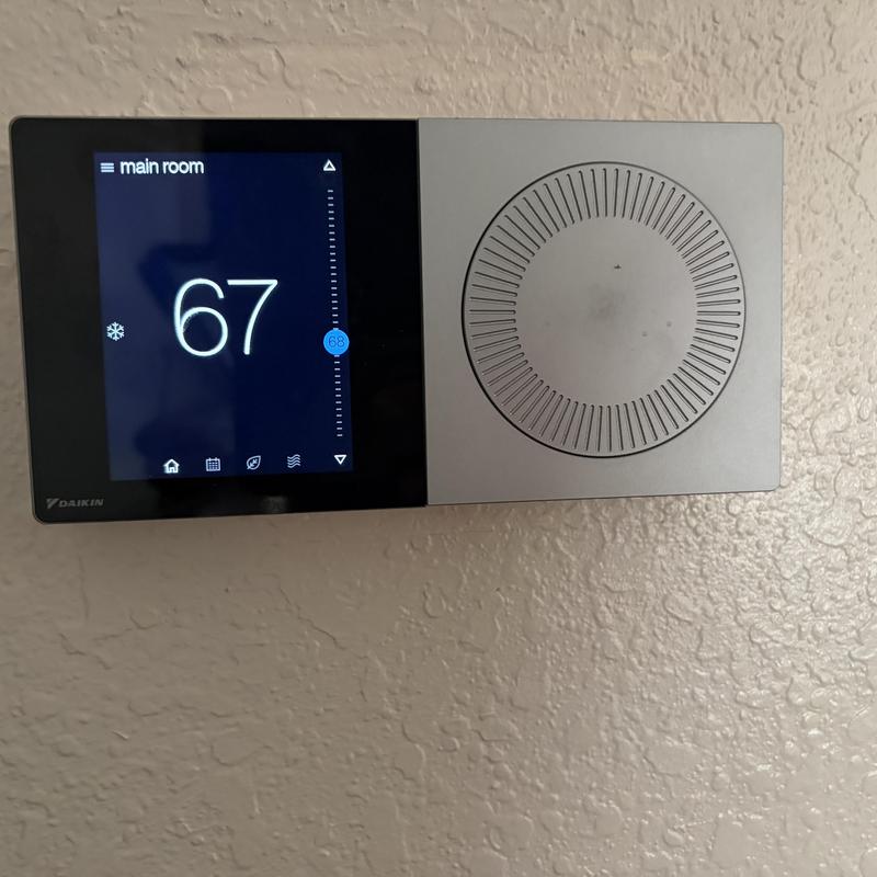 Digital thermostat displaying 67 degrees in main room Digital thermostat displaying 67 degrees in main room