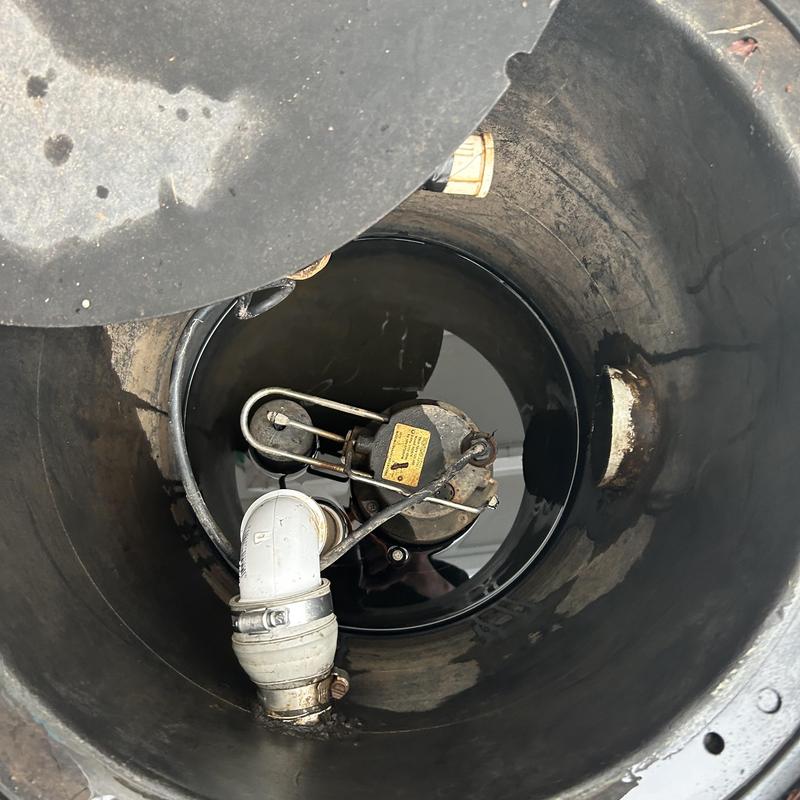 Sump pump and piping inside storm drain basin Sump pump and piping inside storm drain basin
