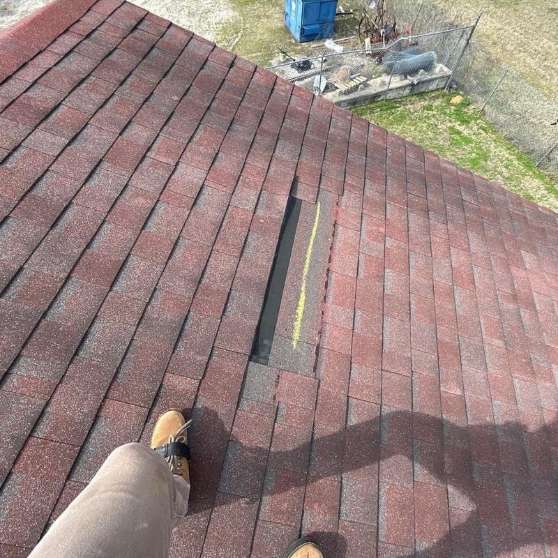 Asphalt roof shingles with hail damage marked for repair