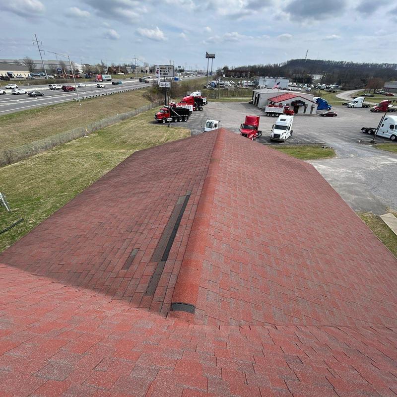 Red asphalt shingle roof with visible ridge and valley