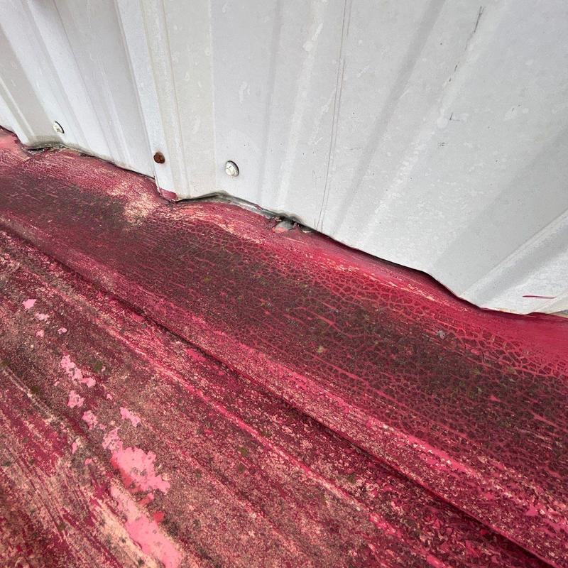 Roof flashing with hail damage and paint deterioration