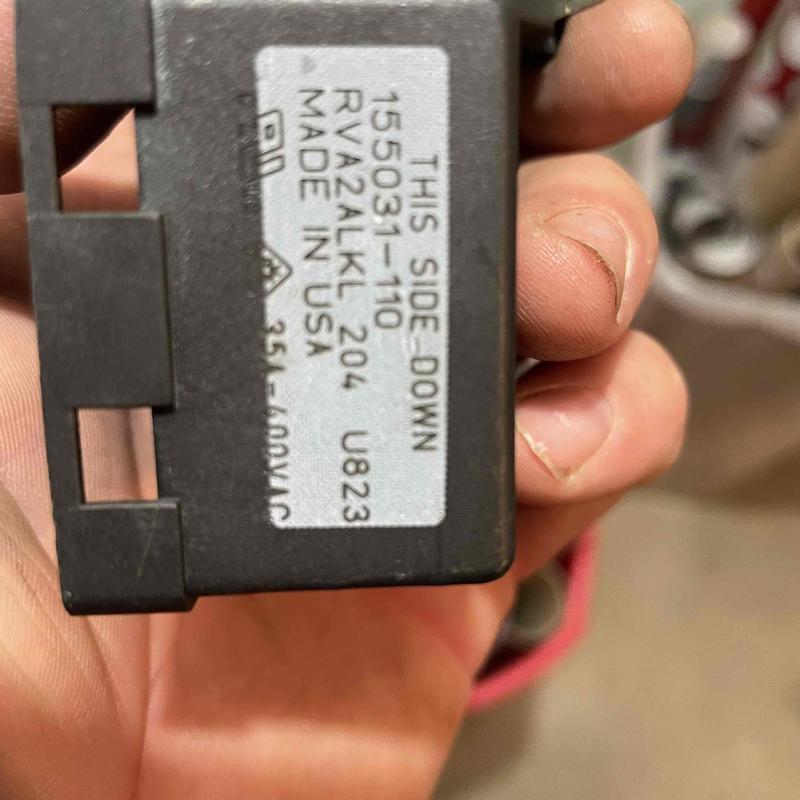 Well pressure switch held by hand, close-up view Well pressure switch held by hand, close-up view