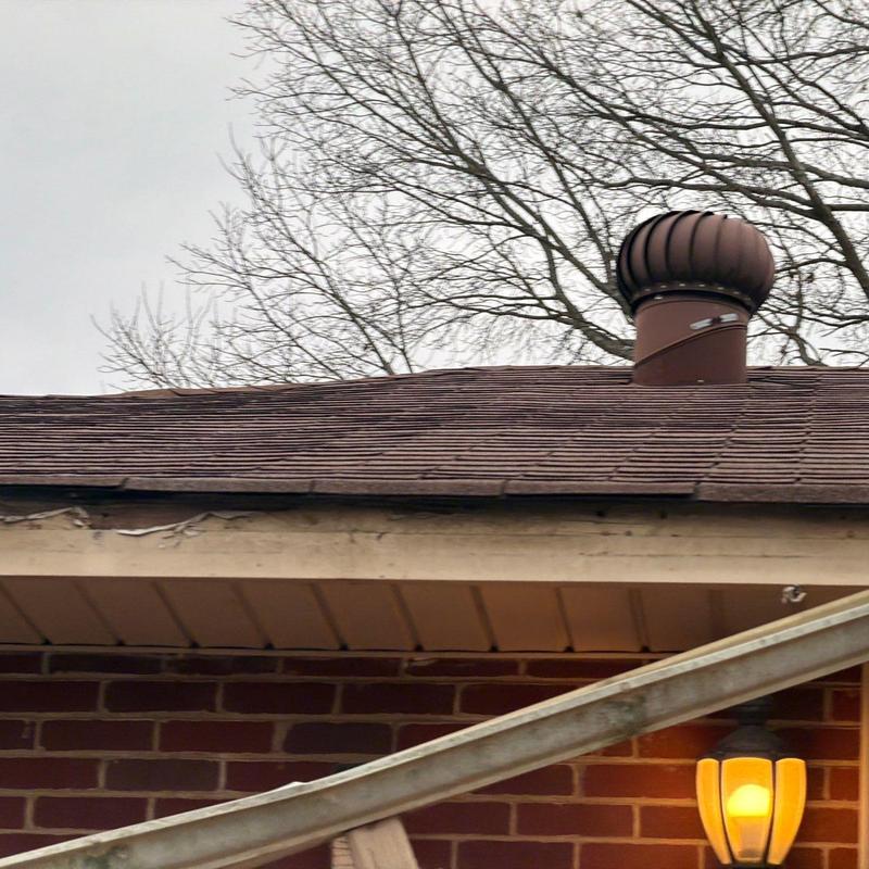 Roof shingles with visible hail damage and ventilation turbine