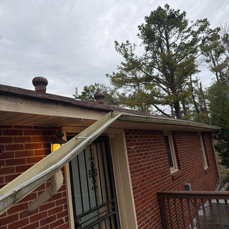 Gutter system inspection on brick house exterior