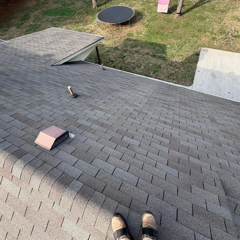 Asphalt shingle roof with vent and pipe flashing