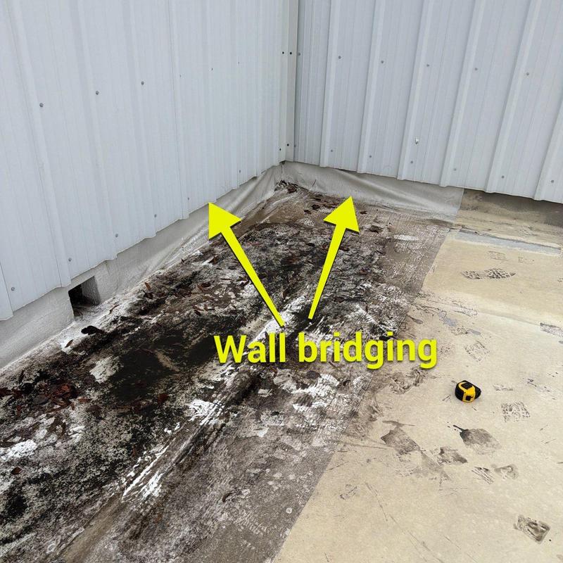 Commercial roof wall bridging and water damage area