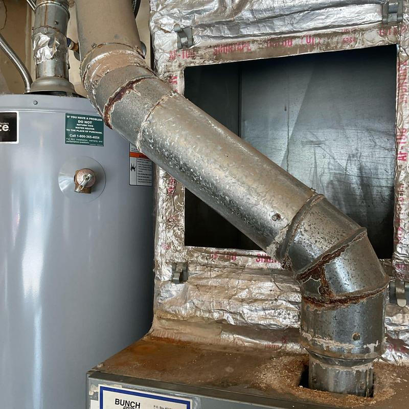 Water heater vent pipe with rusted joints and insulation Water heater vent pipe with rusted joints and insulation