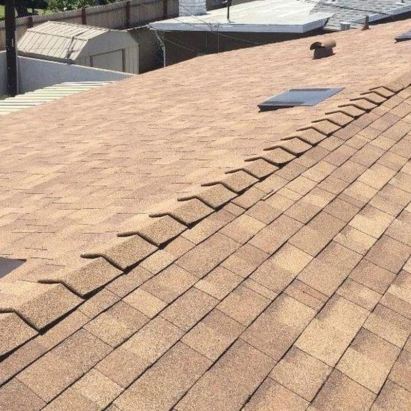 Asphalt shingle roof installation with ridge cap detail Asphalt shingle roof installation with ridge cap detail