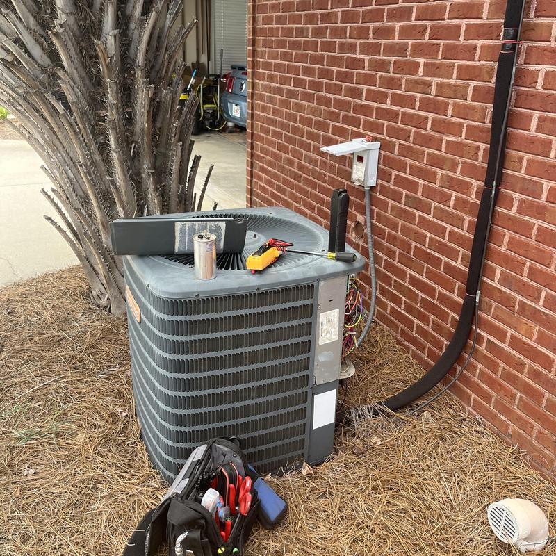 Air conditioner capacitor replacement with tools nearby Air conditioner capacitor replacement with tools nearby