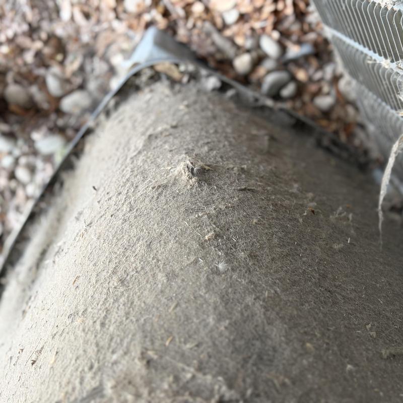 Outdoor AC condenser coils clogged with heavy dirt buildup Outdoor AC condenser coils clogged with heavy dirt buildup